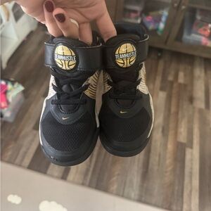 Nike Kids Black and Gold Team Hustle Sneakers